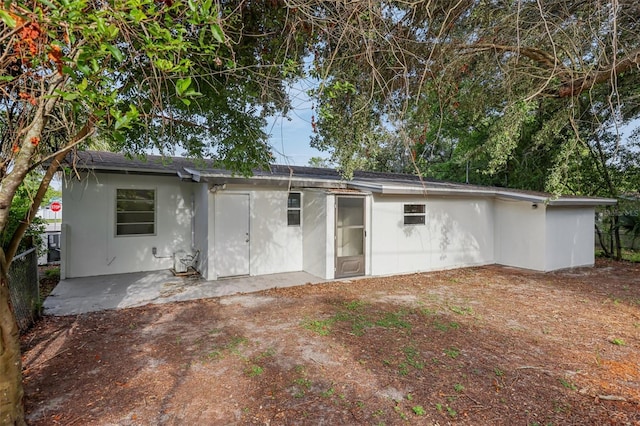 1320 E Lombardy Dr, Deltona, FL 32725 - rear view of house featuring a patio and stucco siding