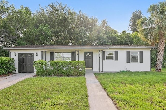1320 E Lombardy Dr, Deltona, FL 32725 - ranch-style home featuring a front yard and stucco siding