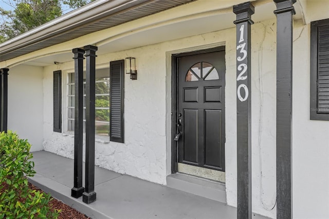 1320 E Lombardy Dr, Deltona, FL 32725 - property entrance featuring covered porch and stucco siding