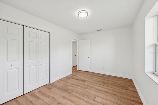 1320 E Lombardy Dr, Deltona, FL 32725 - unfurnished bedroom featuring light wood-style flooring and a closet