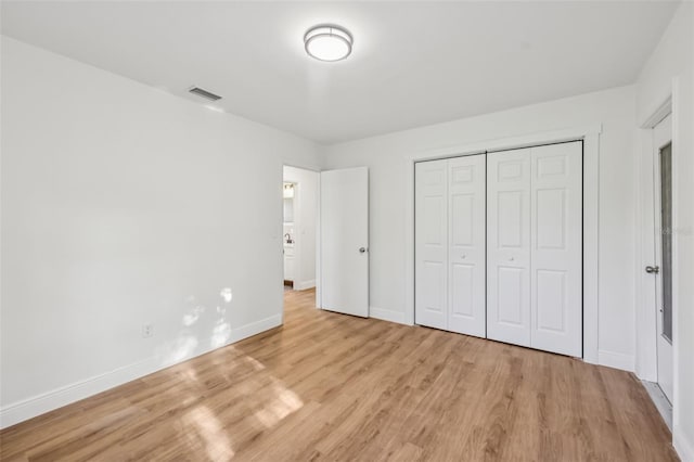 1320 E Lombardy Dr, Deltona, FL 32725 - unfurnished bedroom with light wood-style flooring and a closet