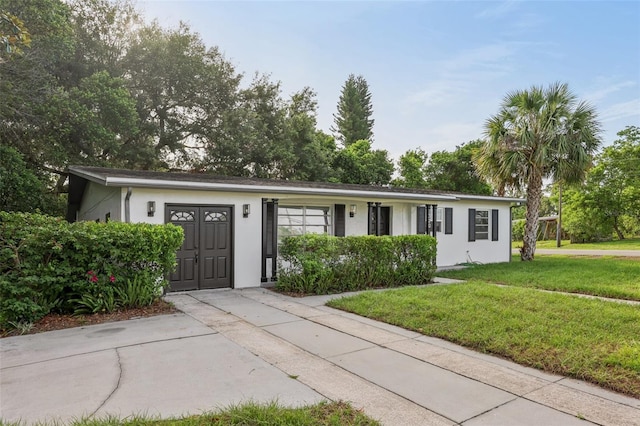 1320 E Lombardy Dr, Deltona, FL 32725 - ranch-style house with a front lawn and stucco siding