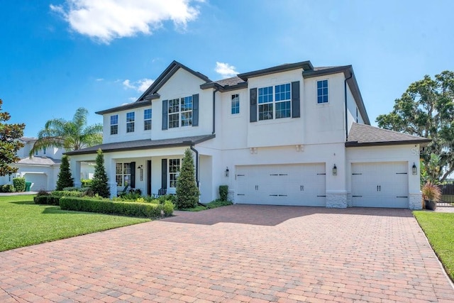 15787 Tangerine Dream Ct, Winter Garden, FL 34787 - traditional home featuring decorative driveway, a front yard, stucco siding, and a garage