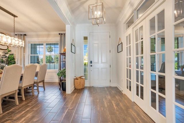 15787 Tangerine Dream Ct, Winter Garden, FL 34787 - foyer with a chandelier, dark wood-style floors, and crown molding