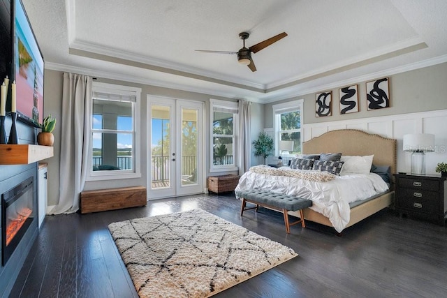 15787 Tangerine Dream Ct, Winter Garden, FL 34787 - bedroom featuring a raised ceiling, access to exterior, dark wood finished floors, crown molding, and french doors