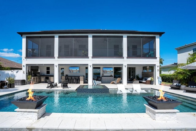 15787 Tangerine Dream Ct, Winter Garden, FL 34787 - rear view of house with an outdoor fire pit, a patio area, and an outdoor pool