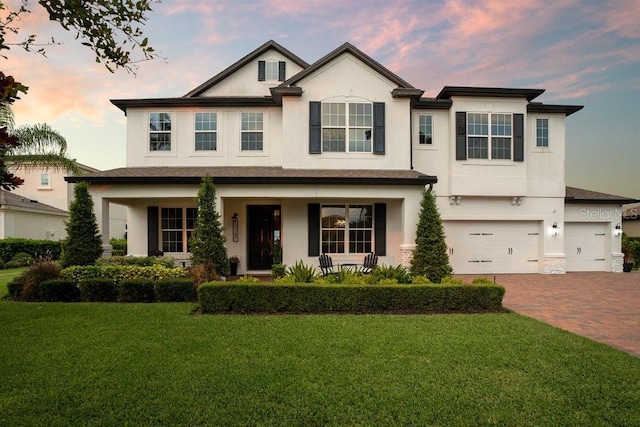 15787 Tangerine Dream Ct, Winter Garden, FL 34787 - view of front facade featuring stucco siding, an attached garage, decorative driveway, and a front yard