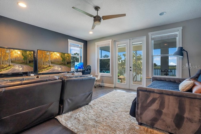 15787 Tangerine Dream Ct, Winter Garden, FL 34787 - living room featuring french doors, wood finished floors, a ceiling fan, recessed lighting, and a textured ceiling