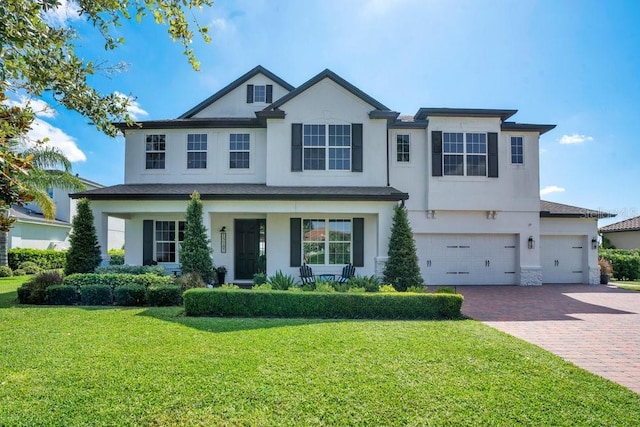 15787 Tangerine Dream Ct, Winter Garden, FL 34787 - view of front of property with stucco siding, decorative driveway, a front yard, and a garage