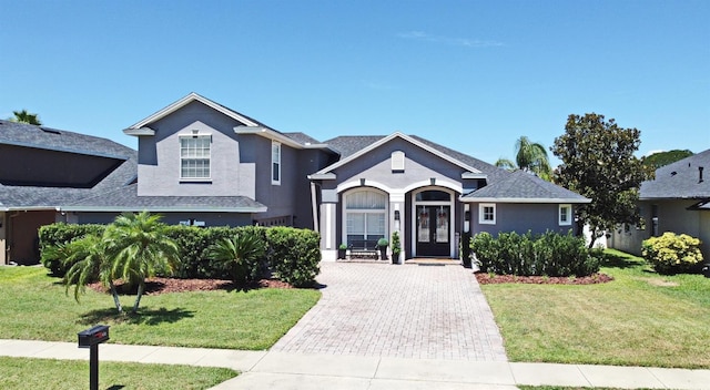 436 Skyview Pl, Chuluota, FL 32766 - view of front of property with stucco siding, a front yard, french doors, and driveway