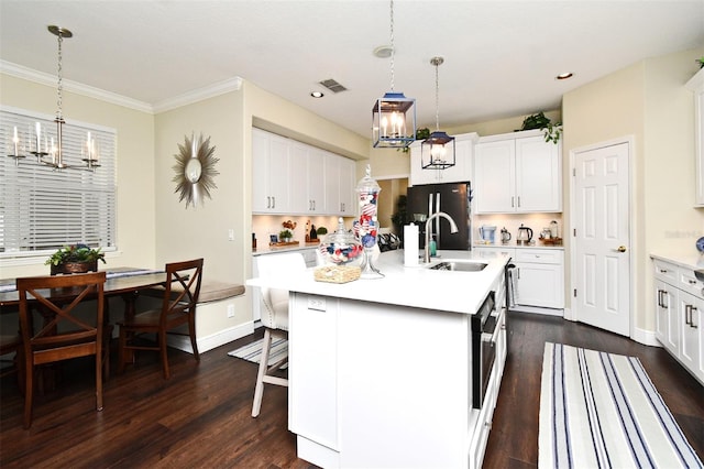 436 Skyview Pl, Chuluota, FL 32766 - kitchen featuring a chandelier, light countertops, freestanding refrigerator, dark wood-style floors, and decorative light fixtures