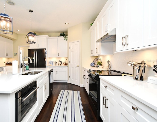 436 Skyview Pl, Chuluota, FL 32766 - kitchen with black appliances, under cabinet range hood, white cabinets, dark wood-style floors, and recessed lighting