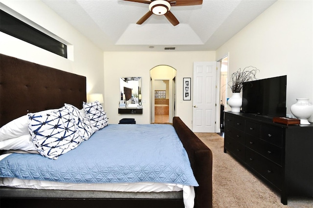 436 Skyview Pl, Chuluota, FL 32766 - bedroom featuring light colored carpet, a raised ceiling, arched walkways, a ceiling fan, and ensuite bath