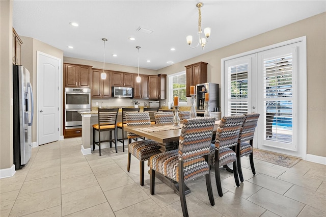 561 Gunston Ct, Davenport, FL 33837 - dining area with a chandelier, light tile patterned floors, and recessed lighting