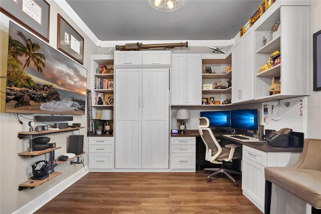 561 Gunston Ct, Davenport, FL 33837 - office area with built in study area, wood finished floors, and crown molding