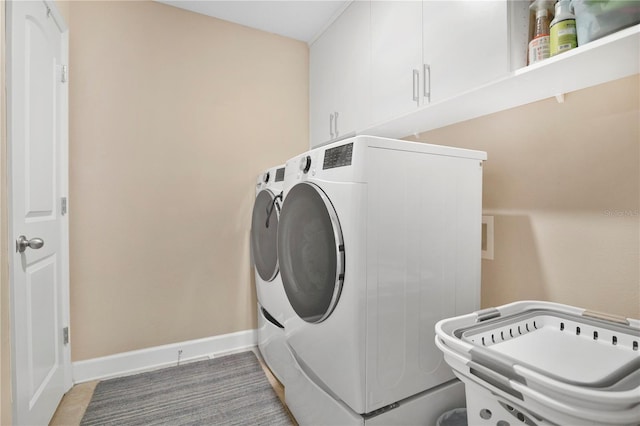 561 Gunston Ct, Davenport, FL 33837 - laundry area with cabinet space and washing machine and clothes dryer