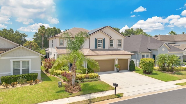 561 Gunston Ct, Davenport, FL 33837 - traditional home with stucco siding, an attached garage, solar panels, driveway, and a front lawn