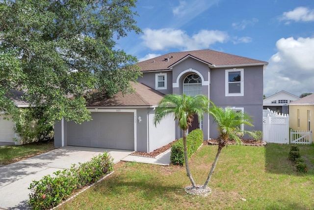 16053 Wilkinson Dr, Clermont, FL 34714 - view of front of home with stucco siding, an attached garage, driveway, and a shingled roof