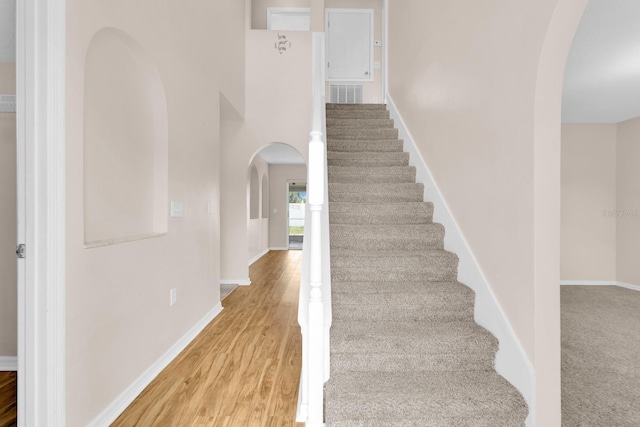 16053 Wilkinson Dr, Clermont, FL 34714 - staircase featuring arched walkways and wood finished floors
