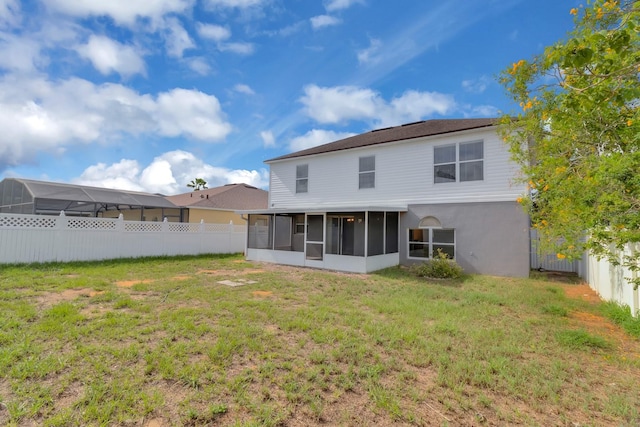 16053 Wilkinson Dr, Clermont, FL 34714 - back of property featuring a sunroom and a fenced backyard