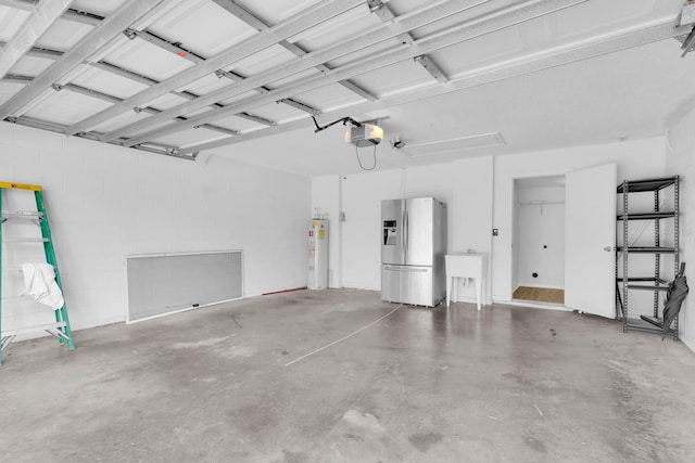 16053 Wilkinson Dr, Clermont, FL 34714 - garage featuring stainless steel fridge, electric water heater, concrete block wall, and a garage door opener