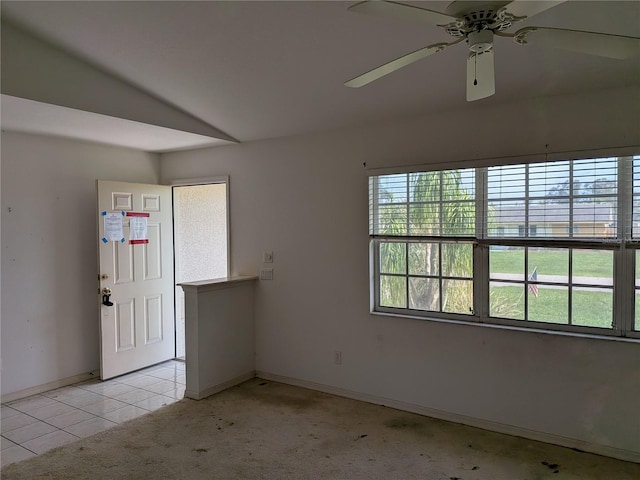 1140 Belmar Ave, Port Charlotte, FL 33948 - empty room featuring lofted ceiling, ceiling fan, light tile patterned flooring, and light colored carpet
