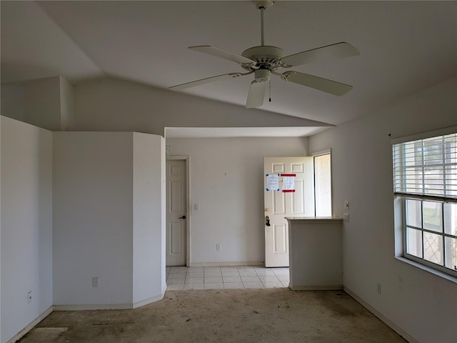 1140 Belmar Ave, Port Charlotte, FL 33948 - spare room featuring vaulted ceiling, light colored carpet, ceiling fan, and light tile patterned flooring