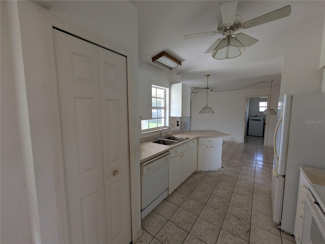 1140 Belmar Ave, Port Charlotte, FL 33948 - kitchen with white appliances, white cabinetry, light tile patterned flooring, a peninsula, and light countertops
