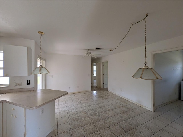 1140 Belmar Ave, Port Charlotte, FL 33948 - kitchen featuring ceiling fan, hanging light fixtures, light countertops, light tile patterned flooring, and a peninsula