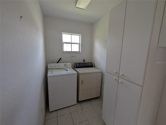 1140 Belmar Ave, Port Charlotte, FL 33948 - laundry area featuring cabinet space, washer and dryer, and light tile patterned floors