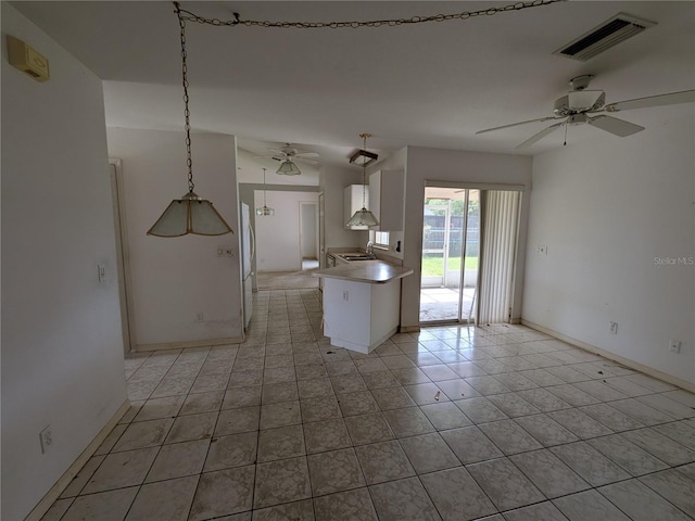 1140 Belmar Ave, Port Charlotte, FL 33948 - kitchen featuring ceiling fan, freestanding refrigerator, white cabinetry, and light tile patterned floors