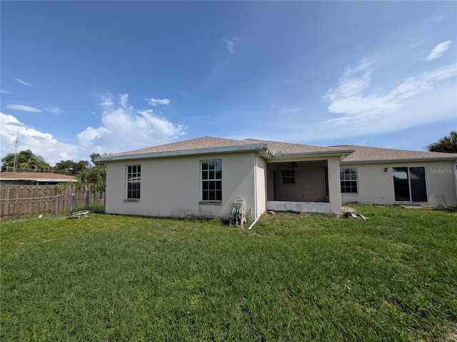 1140 Belmar Ave, Port Charlotte, FL 33948 - back of property featuring stucco siding and ceiling fan