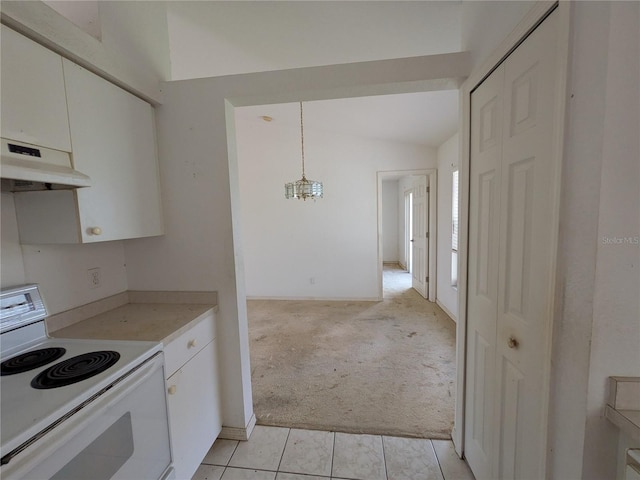 1140 Belmar Ave, Port Charlotte, FL 33948 - kitchen with under cabinet range hood, white range with electric cooktop, light carpet, white cabinetry, and light countertops
