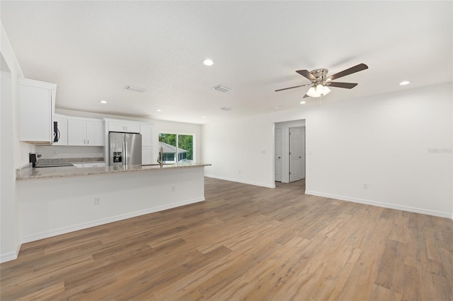13031 NE 7th Loop, Silver Springs, FL 34488 - kitchen featuring stainless steel appliances, white cabinets, ceiling fan, recessed lighting, and a peninsula