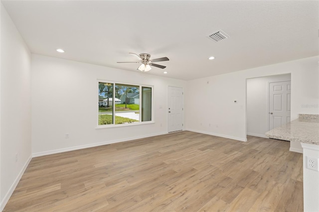 13031 NE 7th Loop, Silver Springs, FL 34488 - unfurnished living room featuring a ceiling fan, light wood finished floors, and recessed lighting