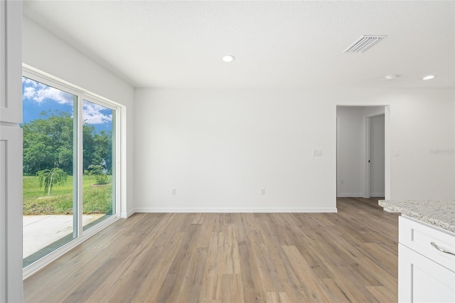 13031 NE 7th Loop, Silver Springs, FL 34488 - empty room with light wood-style flooring, recessed lighting, and a smoke detector