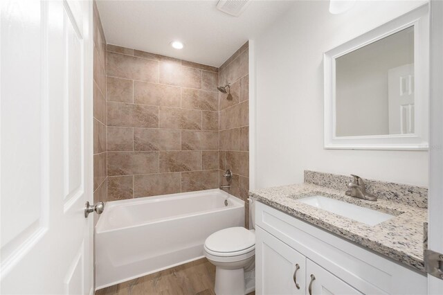 13031 NE 7th Loop, Silver Springs, FL 34488 - bathroom featuring vanity, wood finished floors, shower / bath combination, and recessed lighting