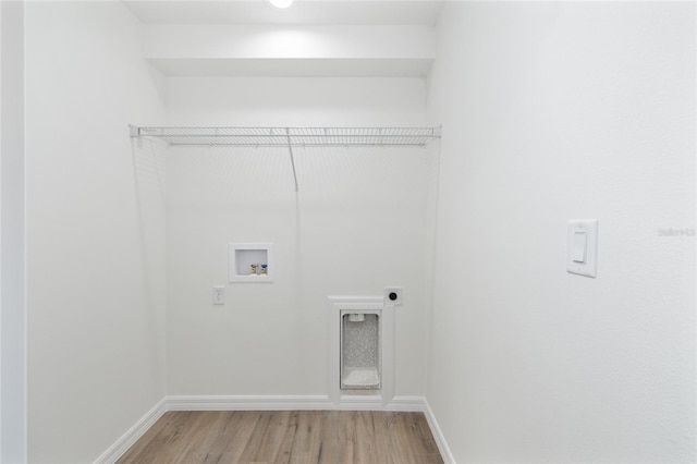 13031 NE 7th Loop, Silver Springs, FL 34488 - laundry room featuring hookup for an electric dryer, hookup for a washing machine, and light wood-style floors