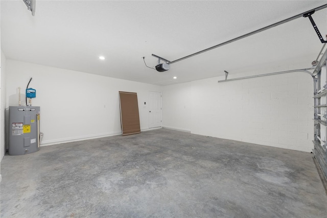 13031 NE 7th Loop, Silver Springs, FL 34488 - garage featuring water heater, a garage door opener, concrete block wall, and recessed lighting