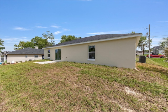 13031 NE 7th Loop, Silver Springs, FL 34488 - back of property with stucco siding, a yard, and a patio