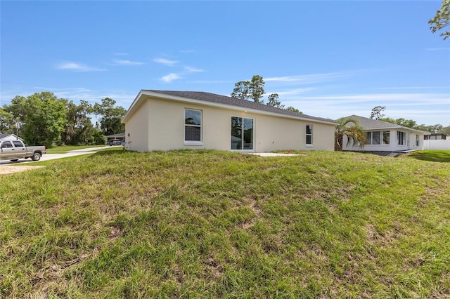 13031 NE 7th Loop, Silver Springs, FL 34488 - view of side of property with stucco siding and a yard