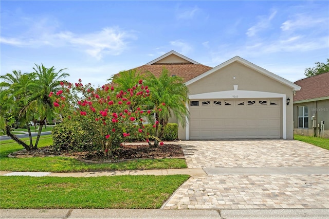 9003 Pecky Cypress Way, Orlando, FL 32836 - view of front of property with a garage, stucco siding, and decorative driveway