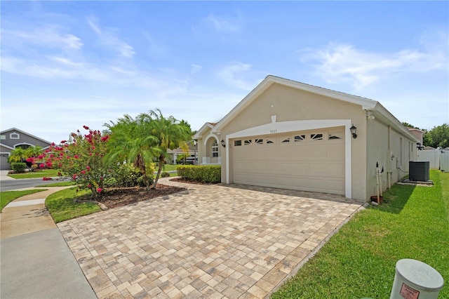 9003 Pecky Cypress Way, Orlando, FL 32836 - view of side of home with stucco siding, a garage, and decorative driveway