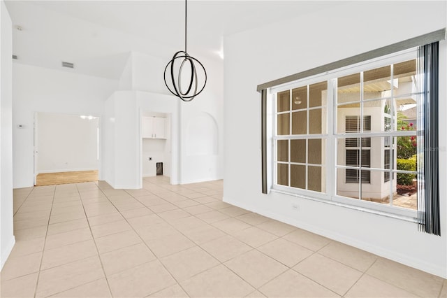 9003 Pecky Cypress Way, Orlando, FL 32836 - empty room featuring light tile patterned flooring and a chandelier
