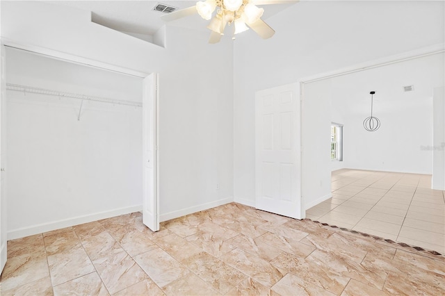 9003 Pecky Cypress Way, Orlando, FL 32836 - unfurnished bedroom with a closet, a ceiling fan, and a high ceiling