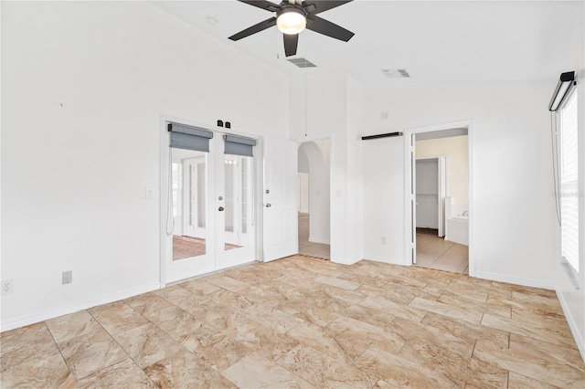 9003 Pecky Cypress Way, Orlando, FL 32836 - unfurnished bedroom with arched walkways, access to exterior, ensuite bath, ceiling fan, and french doors
