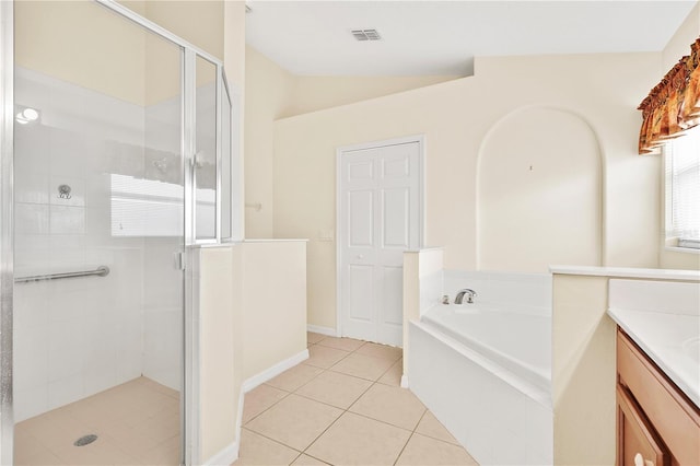 9003 Pecky Cypress Way, Orlando, FL 32836 - full bathroom with tile patterned floors, a shower stall, a bath, vanity, and vaulted ceiling