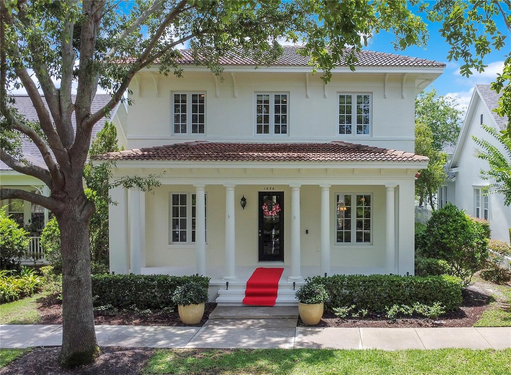 1636 Hanks Ave, Orlando, FL 32814 - view of front facade with stucco siding, a porch, and a tiled roof