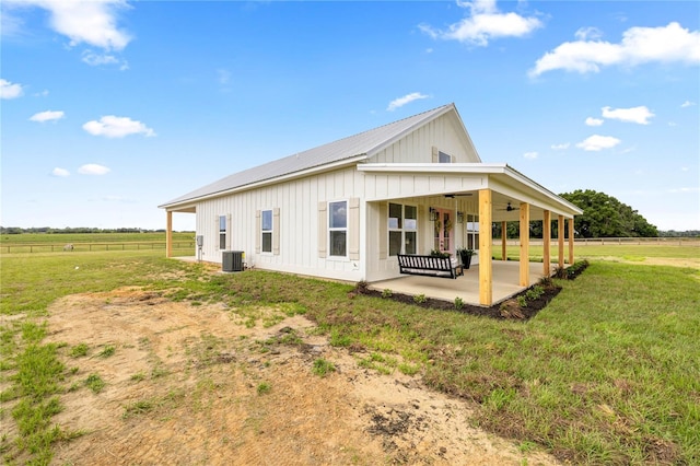 2212 SW 210th Ave, Dunnellon, FL 34431 - view of side of home featuring board and batten siding, ceiling fan, a patio, a metal roof, and a view of countryside