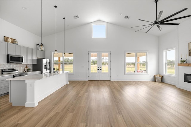 2212 SW 210th Ave, Dunnellon, FL 34431 - kitchen with stainless steel appliances, ceiling fan, open floor plan, light countertops, and high vaulted ceiling